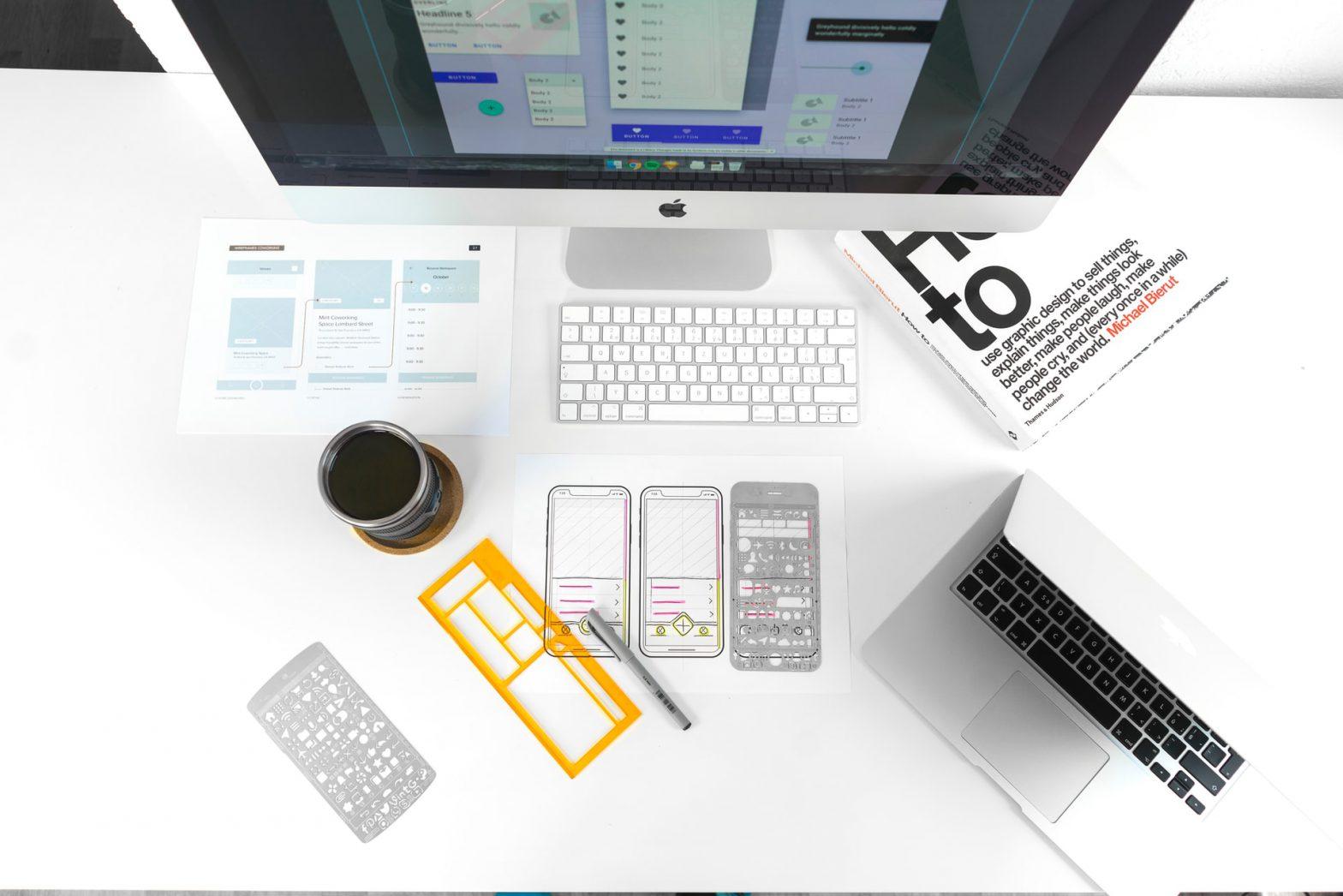 A desk with a monitor displaying web design and WordPress theme work